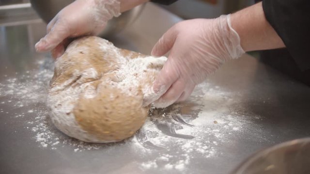 Chef making dough for bread baking on the restaurant kitchen