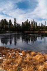 landscape with river and trees and frozen lake
