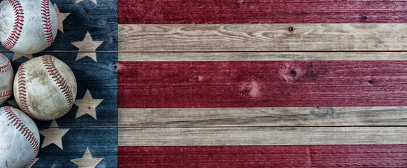 Old baseballs on vintage wooden USA Flag background with copy space