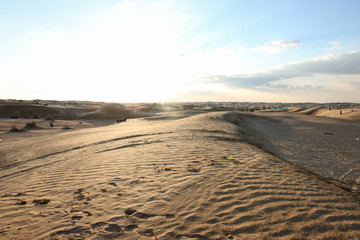 Dunes of Sahara desert with people in the background