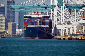 Fully loaded container ship preparing to leave port