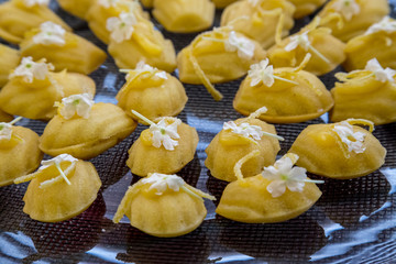 Madeleine's on a tray with flowers sweat pastries