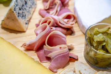 cheese and cold meat board with grapes and bread