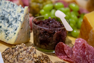 cheese and cold meat board with grapes and bread