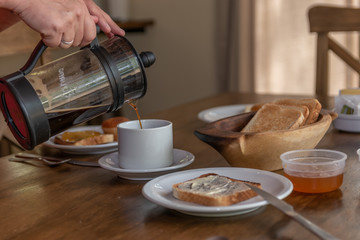 woman serving cup of hot coffee