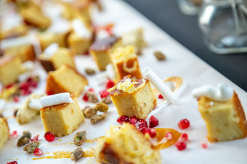 cake squares on a wooden board with chocolate and berries