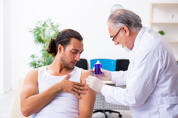 Young male patient visiting experienced doctor