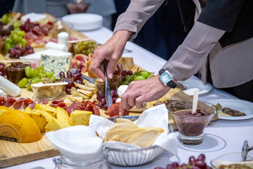 cheese and cold meat board with grapes and bread
