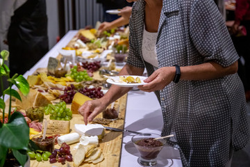 cheese and cold meat board with grapes and bread