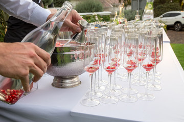 waiter pouring champagne in glass