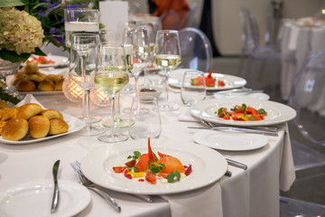 starter salad on a white plate with plated dinner