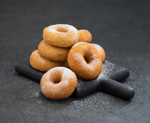  Cottage cheese donuts with powdered sugar on a dark background