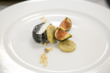 figs and cheese with honey on a white plate