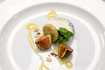 figs and cheese with honey on a white plate