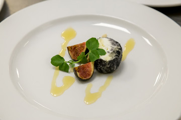 figs and cheese with honey on a white plate
