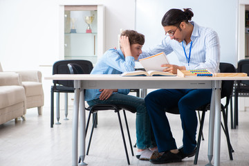 Fototapeta premium Young father helping his son to prepare for exam