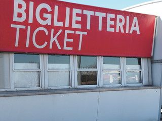 Closed ticket box office windows under big red sign