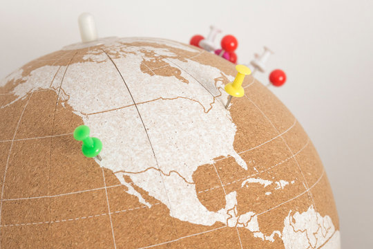 cork world ball showing north america and central america region with colored thumbtacks · plan destinations · visited places · NewYork and California · coast to coast trip