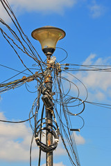 illegal industrial electric cable bulk with insulating tape fixing on metal pylon, power outage,...