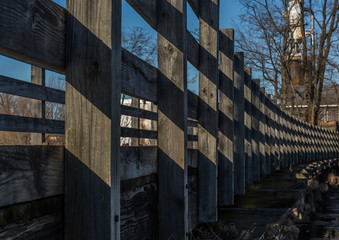 old wooden trestle bridge over Pennsylvania lake with blue skies 
