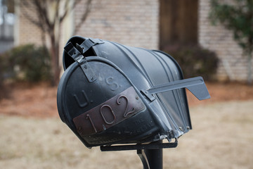 Mailbox that has been hit and damaged by car