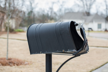 Mailbox that has been hit and damaged by car