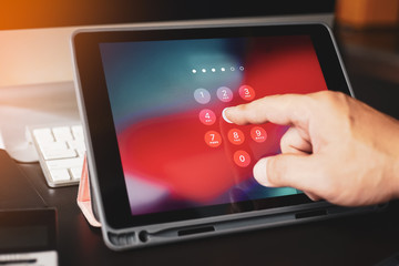  man tying tablet with password login on screen , selective focus