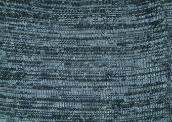 Mottled fabric as a background. Knitted fabric with stripes is grey and black.