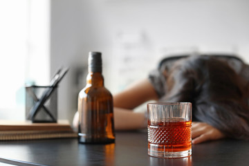 Young drunk woman in office. Concept of alcoholism
