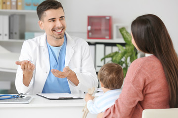 Woman with little baby visiting pediatrician in clinic