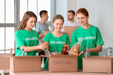 Team of volunteers with products indoors