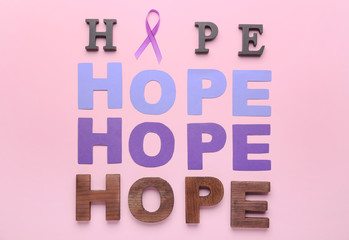 Violet ribbon and words HOPE on color background. Domestic violence concept