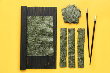 Composition with tasty seaweed sheets on color background © Pixel-Shot