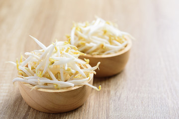 Fresh mung bean sprouts in a bowl on wooden background, organic vegetables