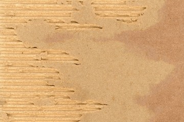 ripped damaged corrugated cardboard background, shredded brown paper overlay for graphic design, damaged recycled cardboard box