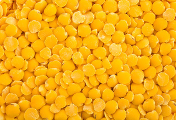 Background of raw yellow lentils. Top view.