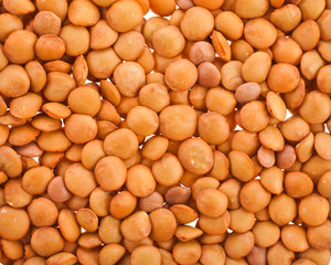 Background of raw brown lentils. Top view.