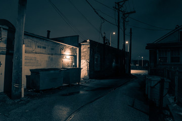 Dark and eerie urban city alley at night in the winter