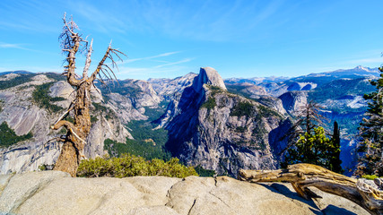 The Sierra Nevada Mountains with the famous Half Dome granite rock formation on the right. Viewed from Glacier Point in Yosemite National Park, California, United Sates