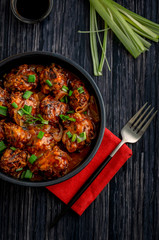 Vegetable manchurian served in a plate with soya sauce and spring onion