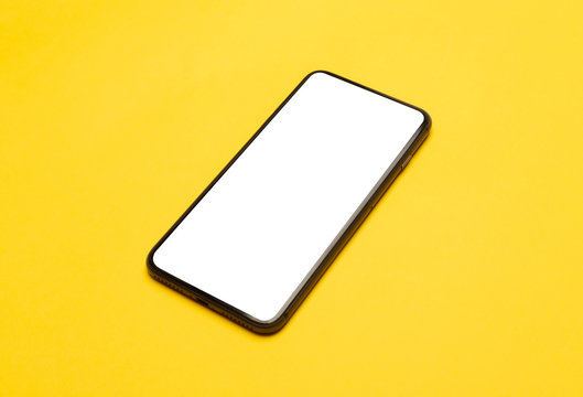 Black smartphone with blank screen mockup isolated on yellow background. Clipping path.