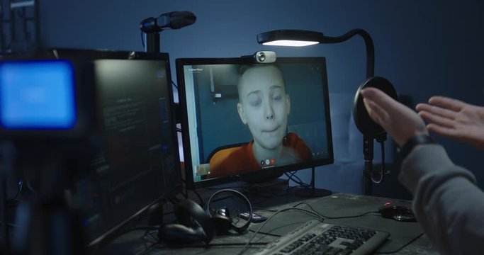 Programmer talking with a boy in a video call
