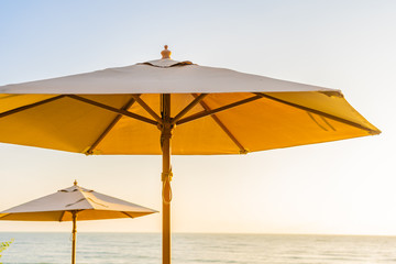 Umbrella and chair around beach sea ocean at sunset or sunrise time