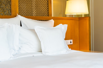 Comfortable white pillow on bed decoration in bedroom