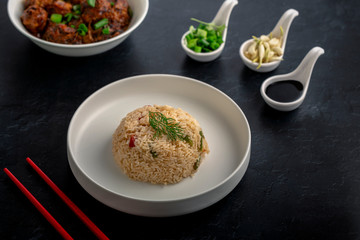  Vegetarian fried rice with manchurian served in a plate