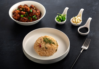  Vegetarian fried rice with manchurian served in a plate