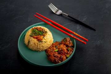 Vegetarian fried rice with manchurian served in a plate