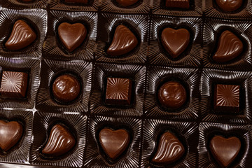 Assorted chocolate candies in a box. Close-up