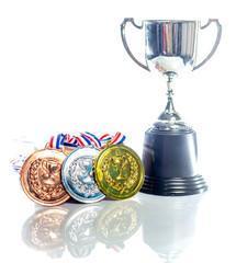Medals - gold, silver and bronze isolated on white. Reflected. Shallow depth of field