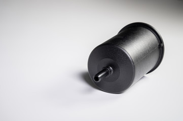 New fuel filter in a black plastic housing for diesel and gasoline engines on a gray background